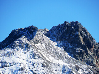 Fototapeta na wymiar First snow on the rocky mountain peak Piz Sarsura (3175 m) in the Albula Alps and above the alpine valley Val Grialetsch, Zernez - Canton of Grisons, Switzerland (Kanton Graubünden, Schweiz)