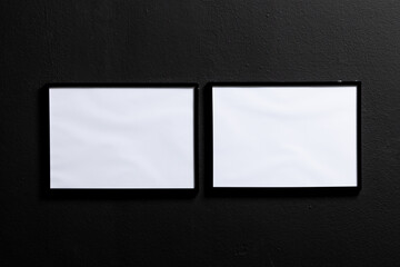 Black empty frames with copy space on black wall