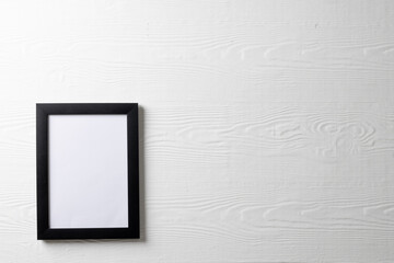 Black empty frame with copy space on white wall