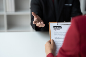 Human resources staff explaining the details of the resume filling out on the chart to the person applying for a job interview with the company. employee job application concept.