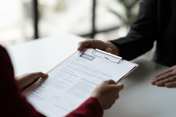 Human resources staff explaining the details of the resume filling out on the chart to the person applying for a job interview with the company. employee job application concept.