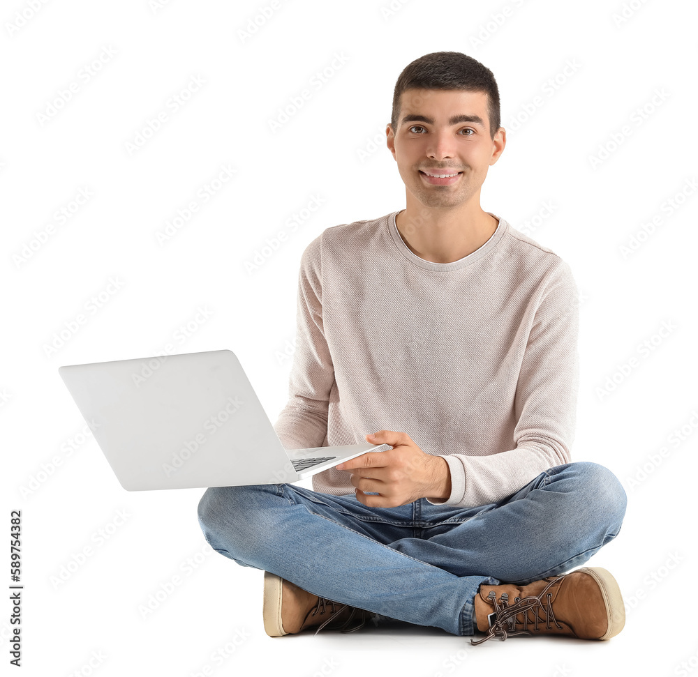 Poster handsome guy with laptop sitting on white background