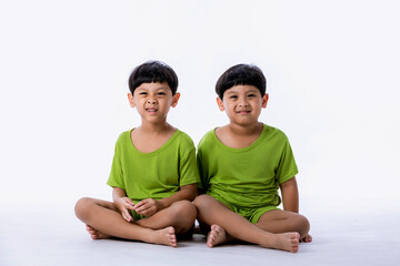 Portrait of cute Asian twins boys. two little boys twins isolated on white background. twins boys fun together on white background