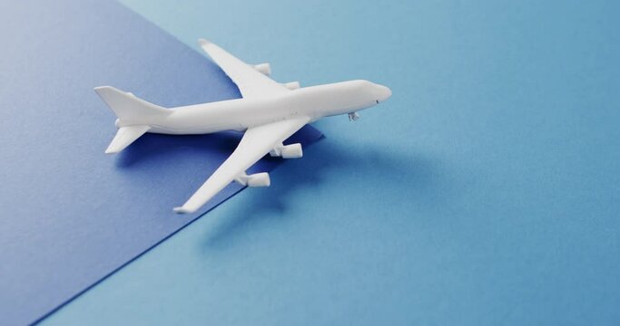 Close up of white airplane model and copy space on blue background