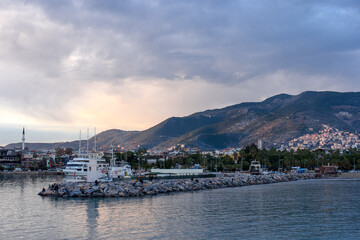 Fototapeta premium Beautiful view on a town, mountains, sea and ships in Alanya port, Turkey