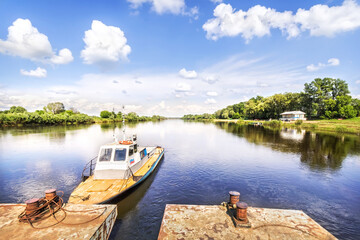 Fototapeta na wymiar Summer landscape on the Klyazma River and a boat at the pier, Gorokhovets