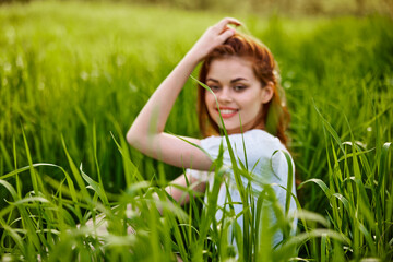 photo of a woman sitting in the grass out of focus