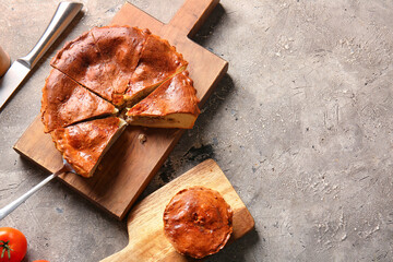 Boards with delicious meat pies on grey grunge table © Pixel-Shot
