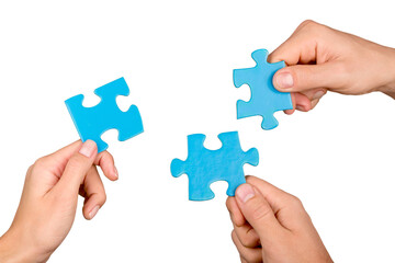 Teamwork, cooperation and partnership concept, human hands holding puzzle pieces - obrazy, fototapety, plakaty