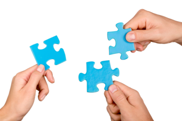 Teamwork, cooperation and partnership concept, human hands holding puzzle pieces