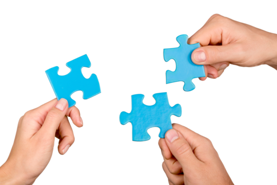 Teamwork, cooperation and partnership concept, human hands holding puzzle pieces