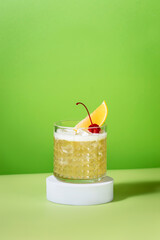 Whiskey sour trendy alcoholic cocktail with bourbon, lemon juice, egg white and ice in glass on bright green background, hard light, minimalism