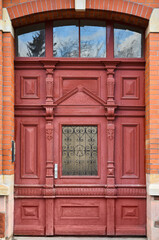 View of brick building with red wooden door