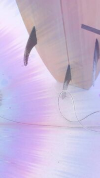 Animation of light moving over feet of surfer on beach holding surfboard
