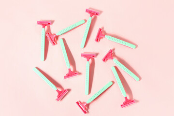 Composition with colorful safety razors  on pink background