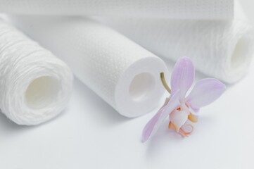 Cartridges for water treatment systems on white background.