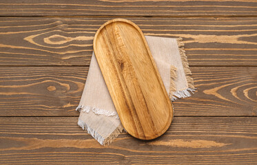 Board and napkin on wooden background
