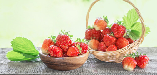 strawberries in baskets on wooden table outdoor