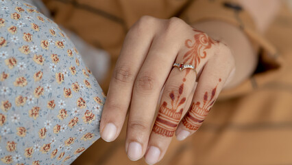 A Muslim girl wearing hijab touching her hijab with her hands