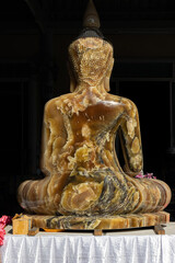 Carved statue of seated Buddha in Buddhist monastery, Thailand