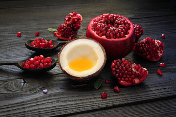 healthy food, diet.Fruits pomegranate, coconut, mint, natural honey.Cardio tablet on a background of bright fruits and honey.composition on an old wooden table.