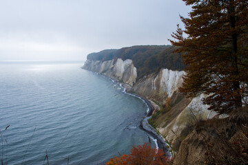 panoramic image of the chalk cliffs of Rügen, Germany with heavy clouds and sunny spots on the...