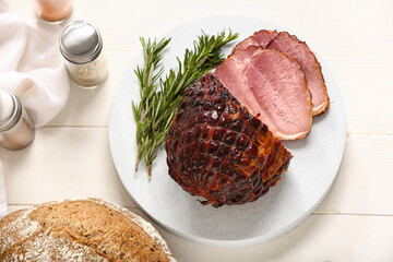 Board with tasty smoked ham on white wooden background