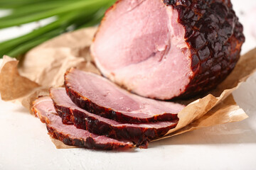 Tasty smoked ham on light background