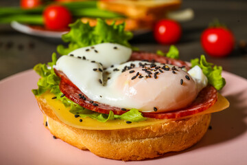 Plate with tasty egg Benedict on table, closeup