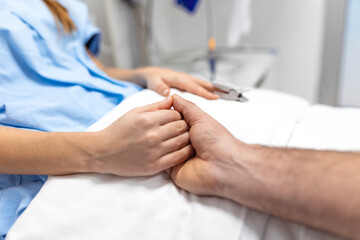 Friendly doctor hands holding patient hand support and hope concept. Male doctors in uniform ,...