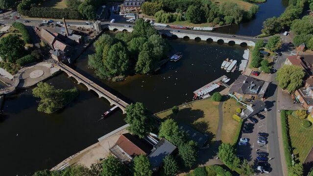 Aerial view orbiting Clopton bridge and river Avon boat house with Coxs yard waterfront restaurant, Stratford upon Avon