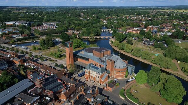 Aerial view orbiting Royal Shakespeare theatre and idyllic river Avon Clopton bridge, Stratford Upon Avon landscape
