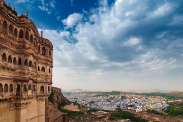 Fototapeta premium Top view of Jodhpur city as seen from famous Mehrangarh fort, Jodhpur, Rajasthan, India. Blue sky in the background. Mehrangarh Fort is UNESCO world heritage site popular amongst tourists worldwide.