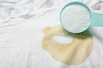 Laundry detergent on stained t-shirt, closeup