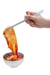 Hand using chopsticks to pick up  Kimchi Or fermented vegetables Korean side dish, Fermented vegetables Korean Traditional food on cup isolate on white with clipping path.