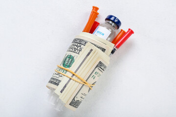 Insulin with syringes and money on white background. Expensive medicine concept