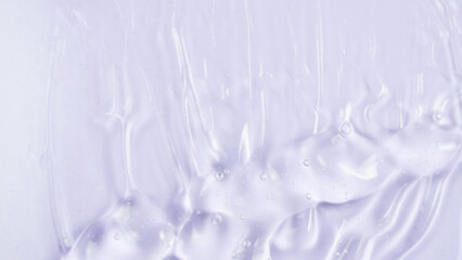 Transparent clear skincare cream with bubbles on white background. Transparent colored cosmetic product close up