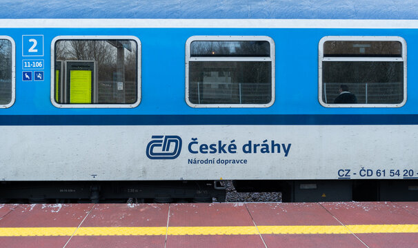 Česk&eacute; dr&aacute;hy passenger train at railway station platform. ČD railroad car, wagon, carriage or compartment coach. Ceske drahy Czech Railways long-distance express on March 24, 2023 in Warsaw, Poland.