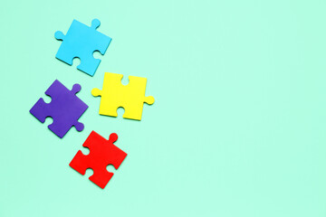 Puzzle pieces on green background. World Autism Awareness Day