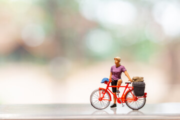 Miniature people standing with bike, World bicycle day concept