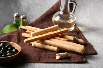 Tasty Italian Grissini on grunge background