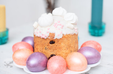 Painted Easter eggs with decorated Easter cake on white background close up with selective focus. Happy Easter concept