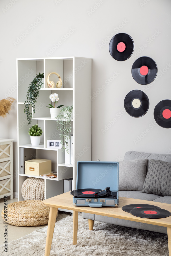 Wall mural record player with vinyl disks on table in interior of living room