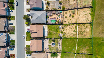Drone photos over the city of Antioch, California on a beautiful sunny day with green hills, streets, houses, cars and solar.