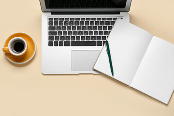 Composition with laptop, coffee and notebook on beige background