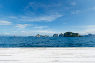 Photo of wooden balcony with sea and mountain backdrop