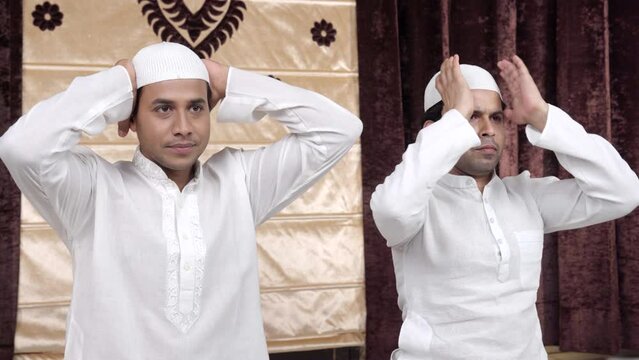 Muslim men performing rituals of Ramadan prayer