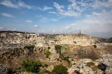 Fototapeta premium Panoramic view of Sassi di Matera a historic district in the city of Matera, well-known for their ancient cave dwellings from the Belvedere di Murgia Timone, Basilicata, Italy