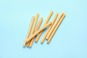 Tasty Italian Grissini on blue background