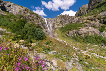 Majestic beautiful bright summer view of the mountain peaks and the Shdugra waterfall, Mazeri in...